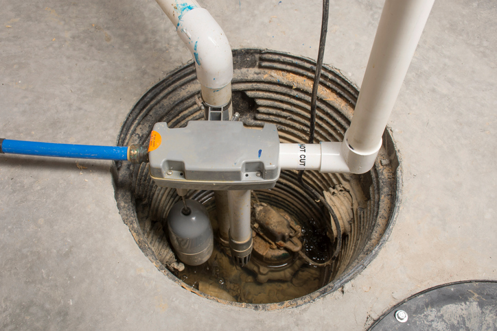 A sump pump installed in a basement of a home with a water powered backup system
