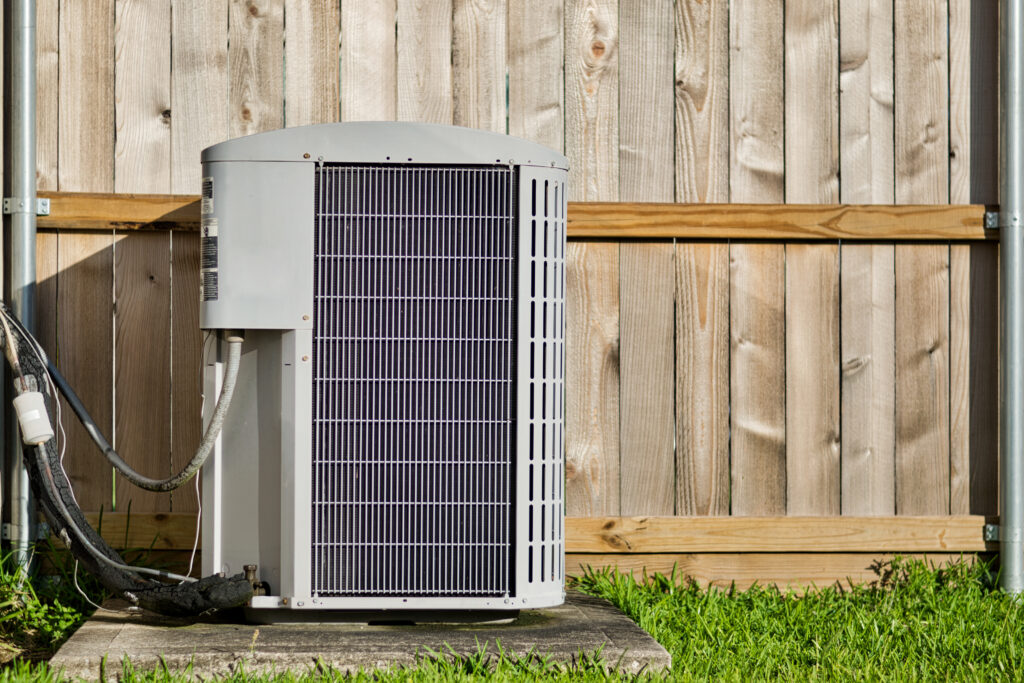 Central air conditioning unit in a residential backyard